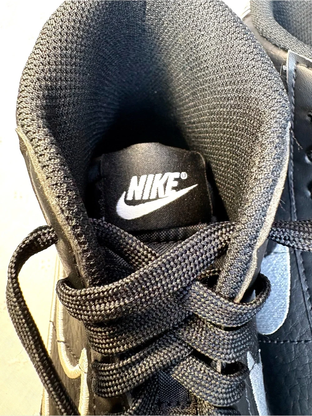 Nike Black High-Top Sneakers with White Tongue Text